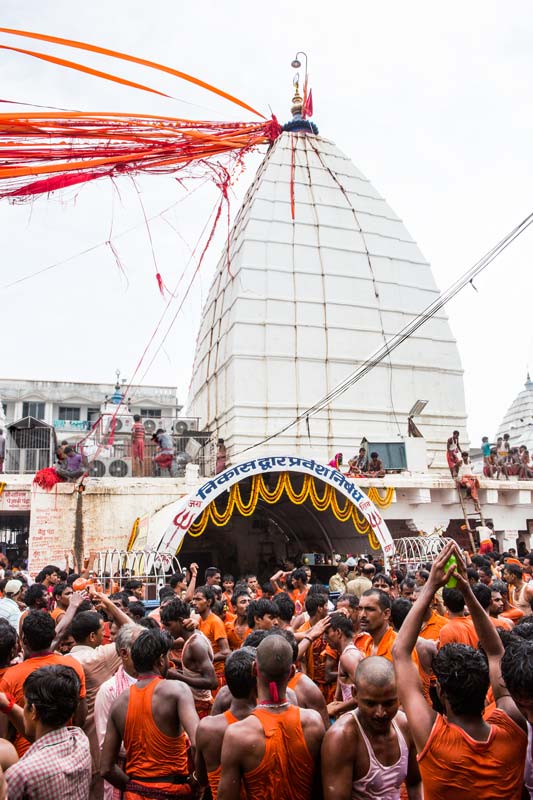 The connection between Water and Religion - Kanwarias rejoicing and paying respect outside the temple at Baba Baidyanath Dham after offering holy Ganga water on the Jyotirling in district Deoghar, Jharkhand